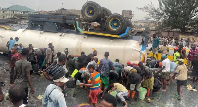 Frenzy as Fuel Tanker Overturns in Lagos, Residents Rush to Scoop Fuel